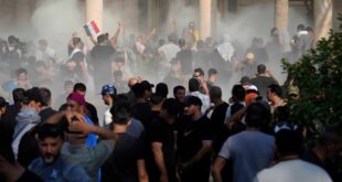 Iraqi security forces fire tear gas on the followers of Shiite cleric Muqtada al-Sadr inside the government Palace, Baghdad, Iraq, Monday, Aug. 29, 2022. 