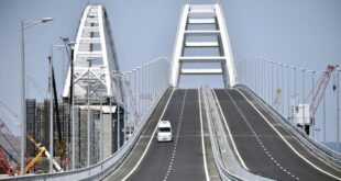 FILE - A vehicle runs down the road-and-rail Crimean Bridge passing over the Kerch Strait and linking southern Russia to the Crimean peninsula on May 15, 2018, in Kerch, prior to the opening ceremony. 