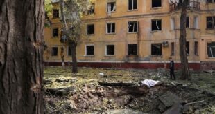 A local resident looks at a crater after a missile strike in Kramatorsk, Donetsk region on September 29, 2022, amid the Russian invasion of Ukraine.