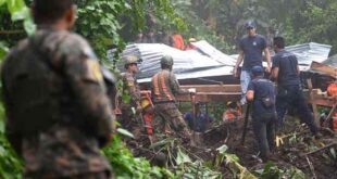 Salvadorian soldiers attempt to retrieve the bodies of five people who died in a landslide in Huizucar, El Salvador, on Sept. 22, 2022.