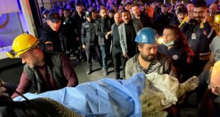 Miners carry the body of a victim in Amasra, in the Black Sea coastal province of Bartin, Turkey, Friday, Oct. 14, 2022. 