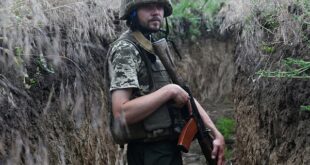 A Ukrainian serviceman Petro, 32, walks in a trench on a position held by the Ukrainian army between southern cities of Mykolaiv and Kherson on June 12, 2022, amid the Russian invasion of Ukraine. 