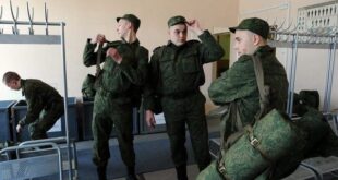 Russian army conscripts put on their uniform at the military registration and enlistment office in St. Petersburg, on April 22, 2014. Tens of thousands of Russian troops are massed on Ukraine's eastern border in what NATO believes is a state of readiness to invade. 