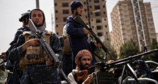 Taliban fighters escort women march in support of the Taliban government outside Kabul University, Afghanistan. 