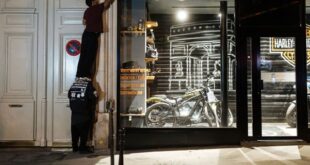 The "On the Spot" collective in France turns off lights at a Paris storefront during a night of action on July 29, 2022, in an effort to save energy ahead of a possible energy crisis in Europe.