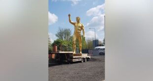 A business owner has slammed the council after he was ordered to remove a 30-foot gold nude statue from outside his shop – after a man reportedly complained it was "obscene."