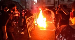 In this Wednesday, Sept. 21, 2022, photo taken by an individual not employed by the Associated Press, and obtained by the AP outside Iran, protesters make fire and block the street during a protest over the death of a woman who had been detained by the morality police, in downtown Tehran, Iran. 