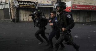 Israeli police are seen here arresting a Palestinian man during clashes in the Shuafat refugee camp in Jerusalem, on Oct.12. 2022.