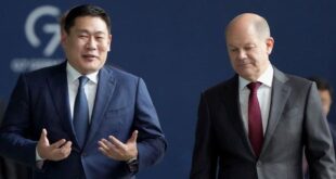 German Chancellor Olaf Scholz (right) and Mongolian Prime Minister Luvsannamsrain Oyun-Erdene (left) speak on their way to a joint press conference in Berlin, Germany, on Oct. 14, 2022.