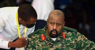 Son of Uganda's President Yoweri Museveni, Lt. Gen. Muhoozi Kainerugaba, right, speaks to Attorney General Kiryowa Kiwanuka, left, at a "Thanksgiving" ceremony in Entebbe, Uganda, on May 7, 2022.