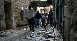 Palestinians gather at the site where Israeli forces destroyed an explosive lab belonging an armed group calling itself the Lions' Den, in the occupied West Bank city of Nablus, Tuesday, Oct. 25, 2022. The military says Israeli forces have raided a stronghold of the group, blowing up the lab and engaging in a firefight. Palestinian health officials say five Palestinians were killed and 20 were wounded. Israel has accused the group of having killed a soldier and attempting several attacks. 